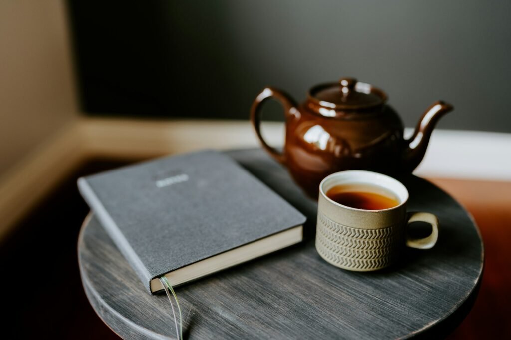 Teapot, tea and book
